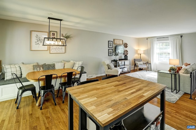 dining space featuring light wood-style floors