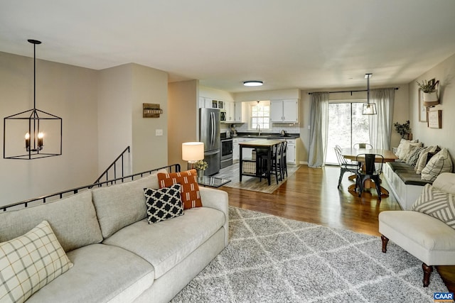 living area with wood finished floors and a chandelier