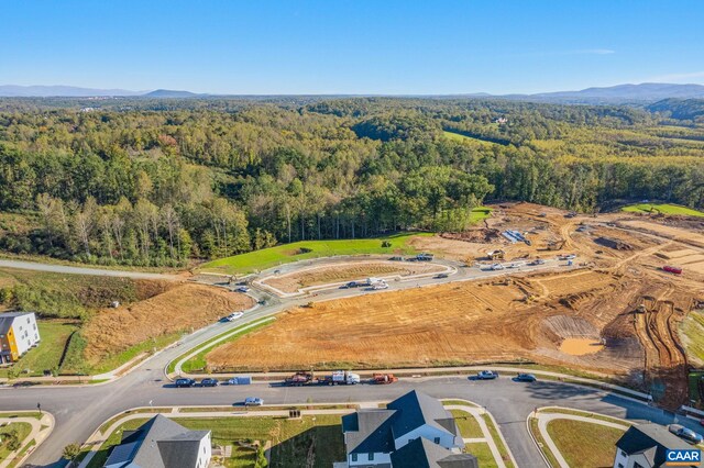 drone / aerial view featuring a mountain view and a forest view