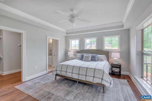 bedroom with ensuite bathroom, ornamental molding, a ceiling fan, wood finished floors, and baseboards