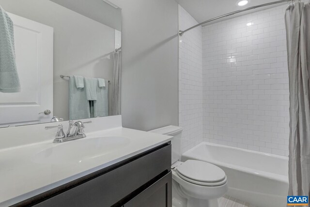 bathroom with shower / bath combo, vanity, and toilet