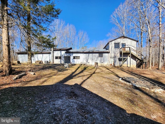 back of house with stairs