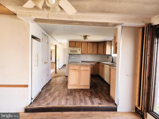 kitchen with a textured ceiling, white appliances, dark wood-style flooring, and a kitchen island