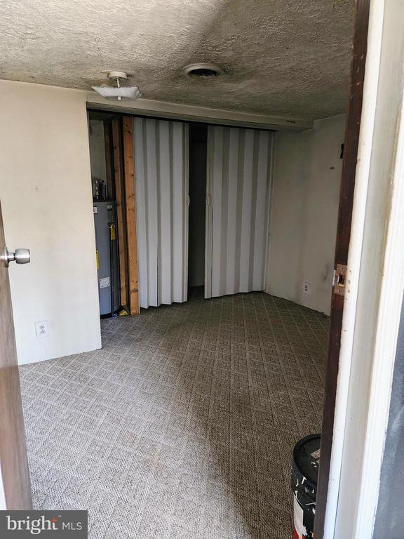 interior space featuring gas water heater and a textured ceiling