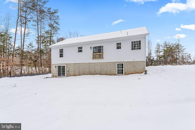 view of snow covered back of property