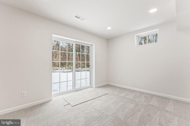 unfurnished room with light carpet