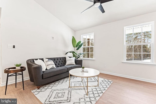 living room with vaulted ceiling, ceiling fan, and light hardwood / wood-style floors