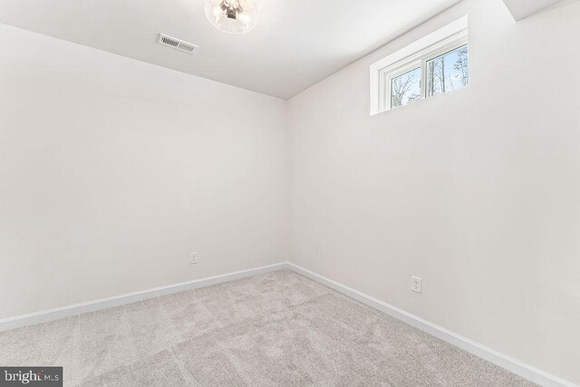 unfurnished room featuring light colored carpet