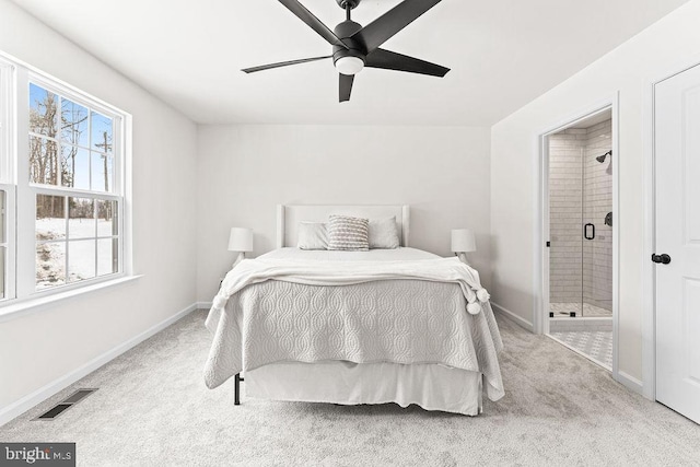 carpeted bedroom featuring ceiling fan and ensuite bathroom