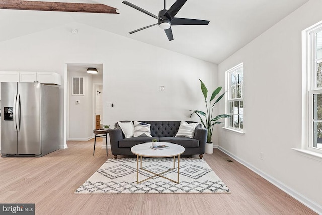 living room with ceiling fan, lofted ceiling with beams, and light hardwood / wood-style flooring