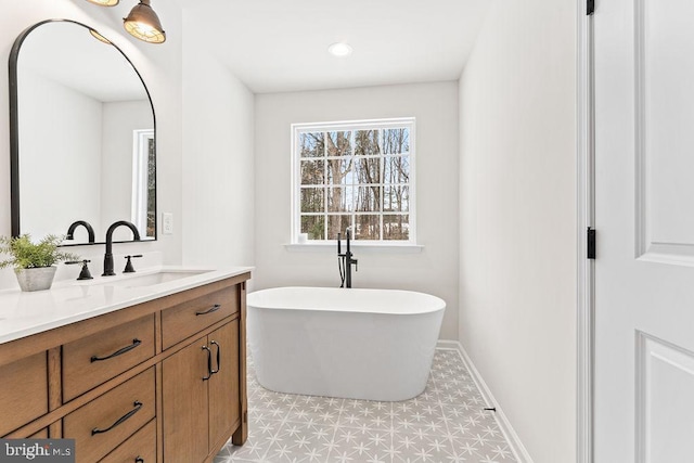 bathroom with vanity and a bath