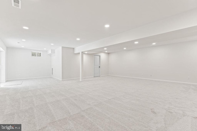 basement featuring light colored carpet