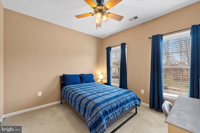 bedroom featuring light carpet, visible vents, and baseboards