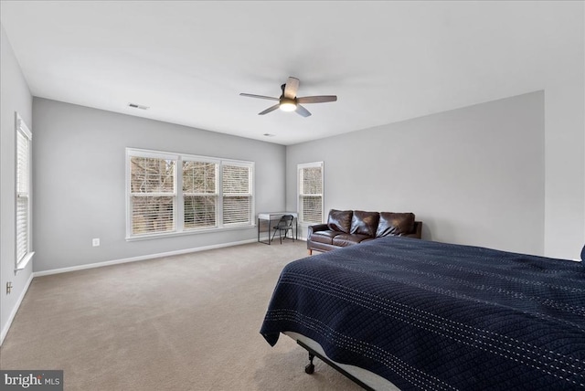 carpeted bedroom with ceiling fan, visible vents, and baseboards