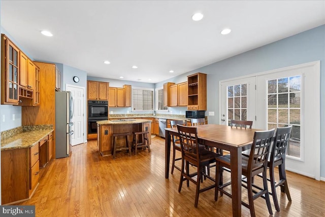 dining space featuring light wood-style flooring and recessed lighting