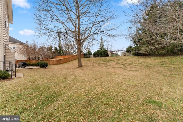 view of yard featuring fence and a patio