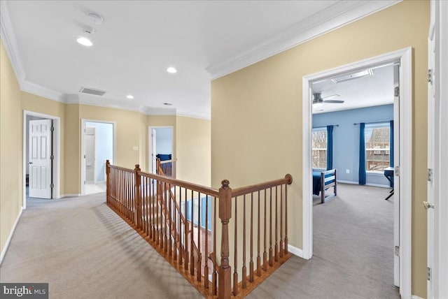 hallway with carpet, baseboards, and an upstairs landing