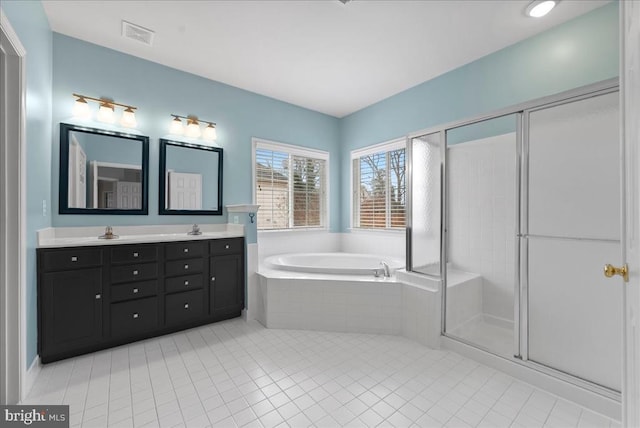 full bath featuring double vanity, a sink, a shower stall, a bath, and tile patterned floors