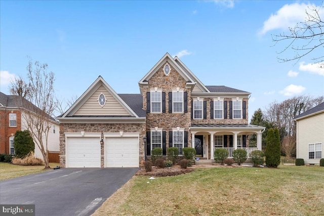 view of front facade with aphalt driveway, a porch, a front yard, a garage, and stone siding