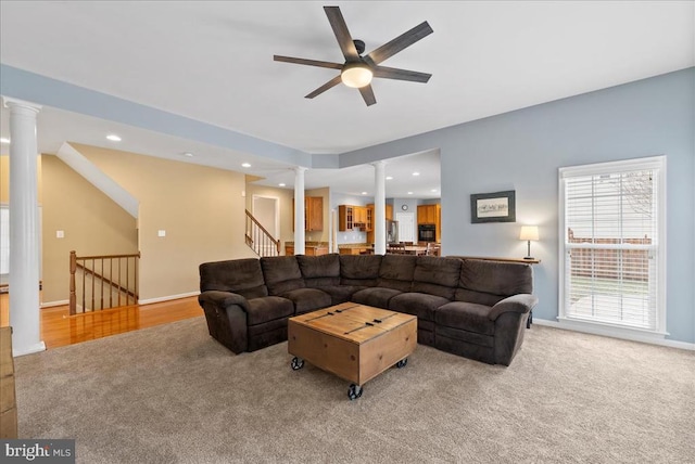 living room with decorative columns, baseboards, carpet flooring, and recessed lighting