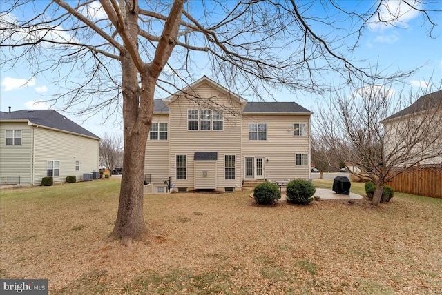 rear view of property featuring a yard, central AC unit, entry steps, a patio area, and fence