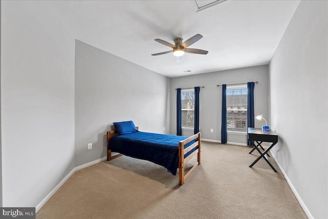 carpeted bedroom featuring ceiling fan and baseboards