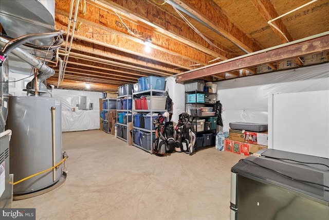 unfinished basement featuring electric panel and water heater