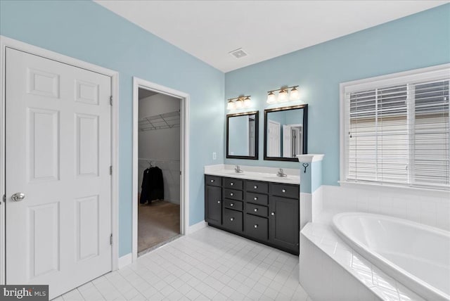 full bathroom with a garden tub, a sink, visible vents, and double vanity