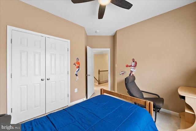 carpeted bedroom with a closet, ceiling fan, and baseboards