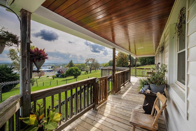 deck with a yard and covered porch