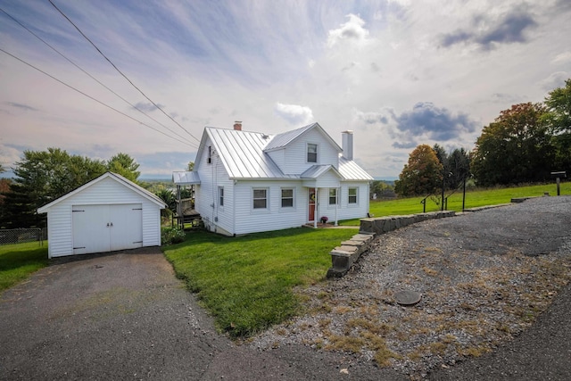 view of front of house with a front lawn and a storage shed