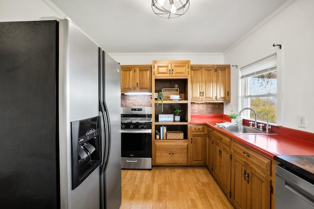 kitchen featuring sink, light hardwood / wood-style flooring, stainless steel appliances, ornamental molding, and decorative backsplash