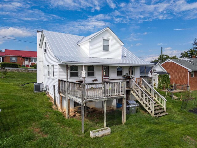 rear view of property with a deck, a yard, and central AC unit