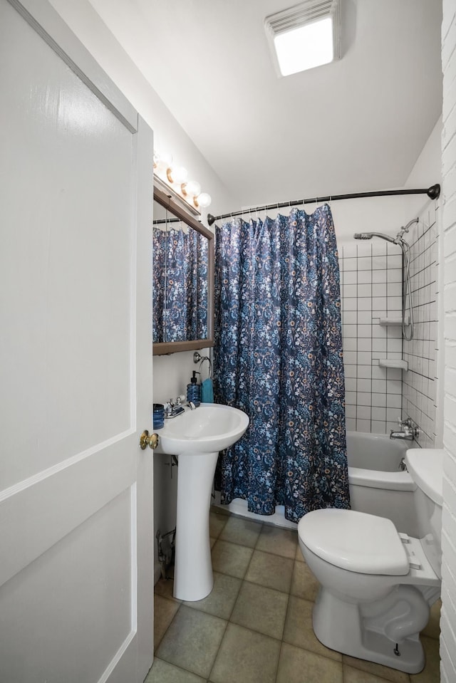 full bathroom featuring toilet, sink, tile patterned floors, and shower / bath combo with shower curtain