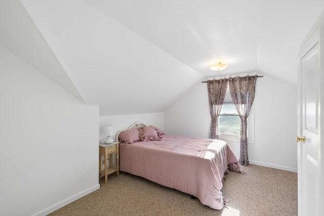 carpeted bedroom with vaulted ceiling