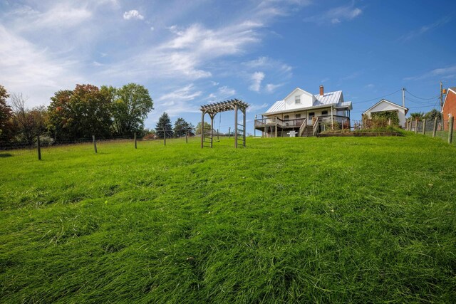 view of yard with a rural view and a pergola