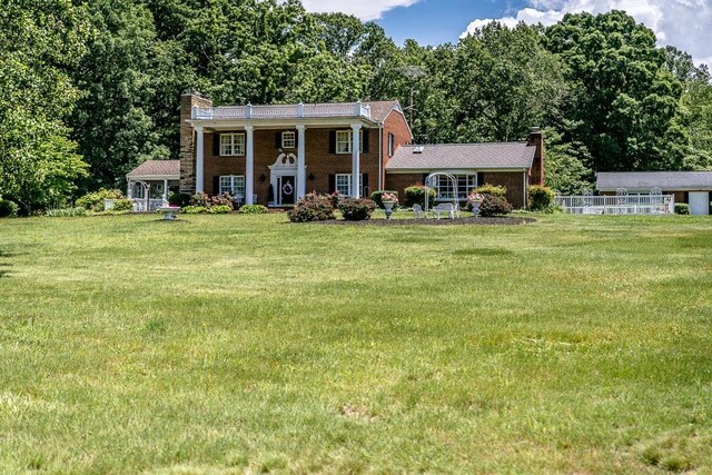 greek revival house with a front yard