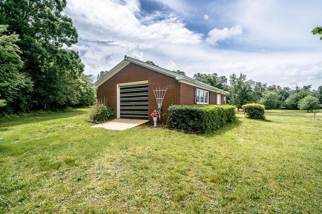 view of side of property with a yard