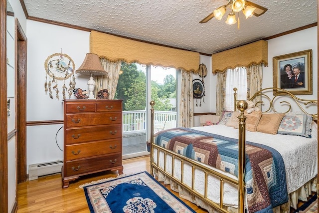 bedroom with a baseboard heating unit, access to exterior, ornamental molding, light hardwood / wood-style floors, and a textured ceiling