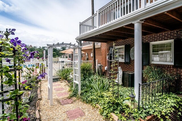 view of patio featuring a balcony and a pergola