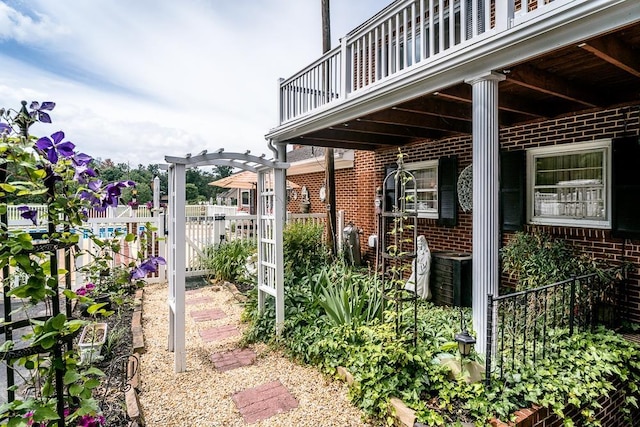 view of patio featuring a balcony and a pergola