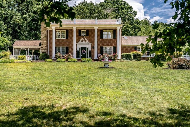 greek revival inspired property with a front lawn