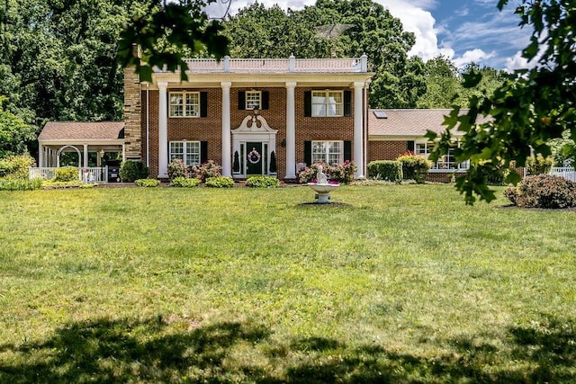 greek revival inspired property with a front lawn