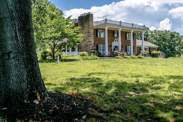 greek revival house featuring a front lawn