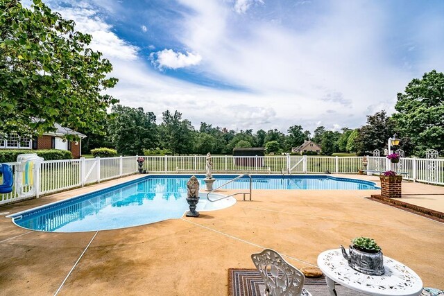 view of swimming pool featuring a patio area