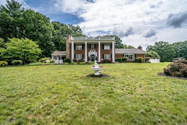 neoclassical / greek revival house with a front lawn