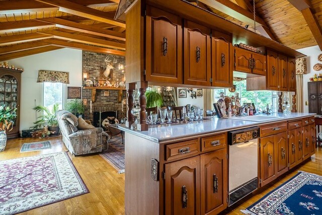 kitchen featuring wood ceiling, white dishwasher, lofted ceiling with beams, a brick fireplace, and light wood-type flooring