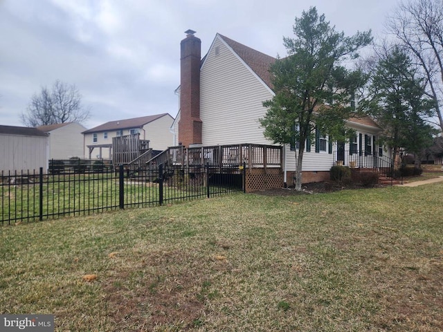 exterior space with a wooden deck, a yard, and fence