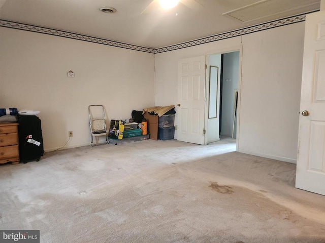 garage featuring visible vents, baseboards, and a ceiling fan