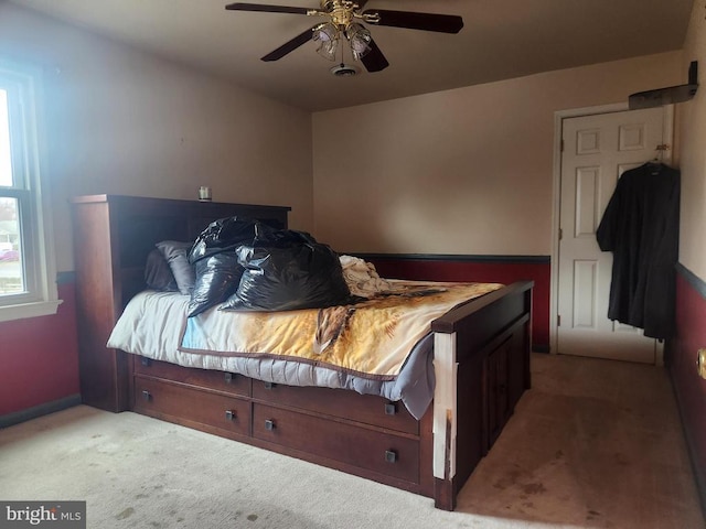 carpeted bedroom featuring ceiling fan